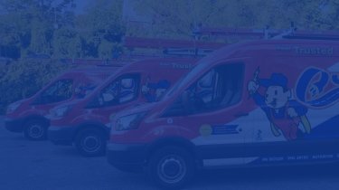 3 red, white and blue electrician service vans parked beside one another